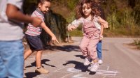 Photo of elementary school children playing hopscotch