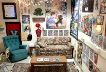 A classroom nook with a couch, armchair, and coffee table